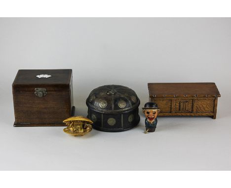 An early 20th century oak playing card box with enamel decoration to top, a carved wood trinket box with metal banding, a mus