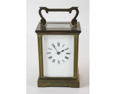 A brass and bevelled glass cased carriage clock, the white enamel dial with Roman numerals, 15cm high
