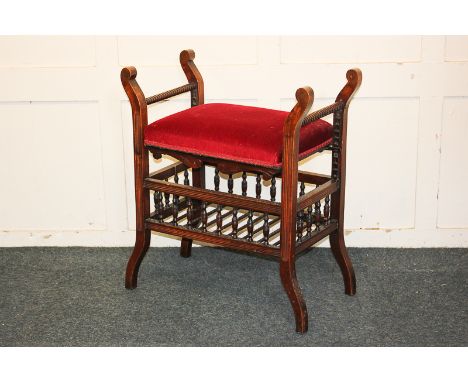 A Victorian piano stool, rectangular upholstered seat, with ratchet action height adjustment and slatted under-shelf, on scro