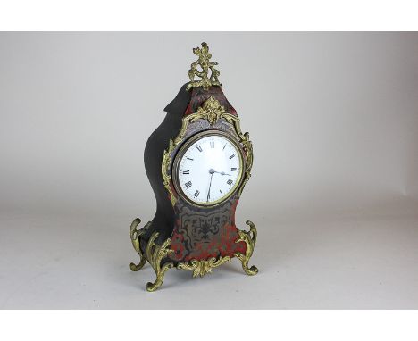 A 19th century French boulle clock, the circular white enamel face with Roman numerals and ormolu surround, 30cm high