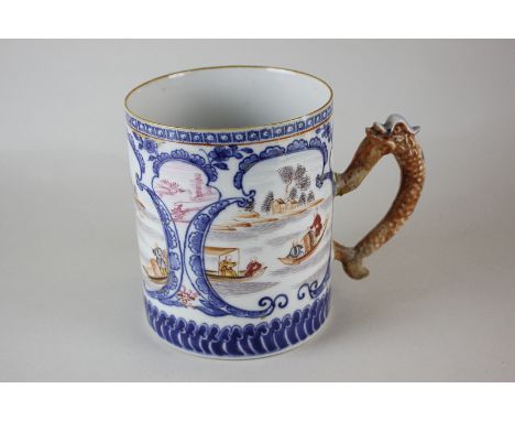 A Chinese porcelain tankard decorated with three scenes of barges on a river, the handle modelled as a fish with scales (a/f)