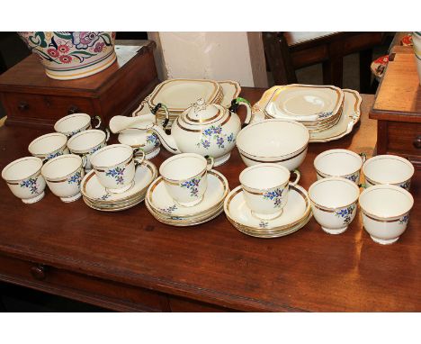 A Tuscan china Art Deco tea service for twelve with teapot, sugar bowl, milk jug, two cake plates, twelve sandwich plates, sa