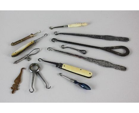 A collection of twelve Victorian and later button hooks, some with decorative handles in mother of pearl, glass and ivory, ot