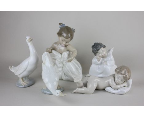 Two Lladro porcelain figures of a sleeping cherub and a sleeping child, together with a Nao porcelain figure of a baby girl a