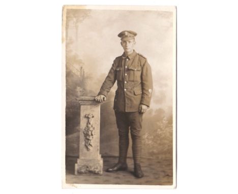 Northumberland Fusiliers WWI Full length uniformed Fusilier standing, 'LG' patch and wound strip on sleeve. 
