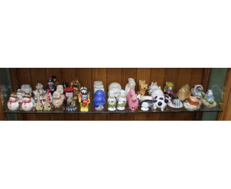 A SHELF FULL OF NOVELTY CRUETS VARIOUS 