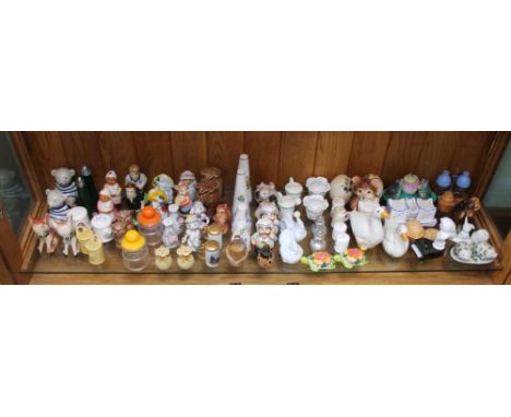 A SHELF FULL OF NOVELTY CRUETS VARIOUS 