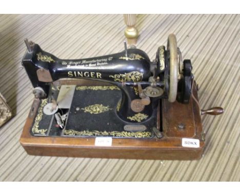 A WOODEN BASED MANUAL SINGER SEWING MACHINE 