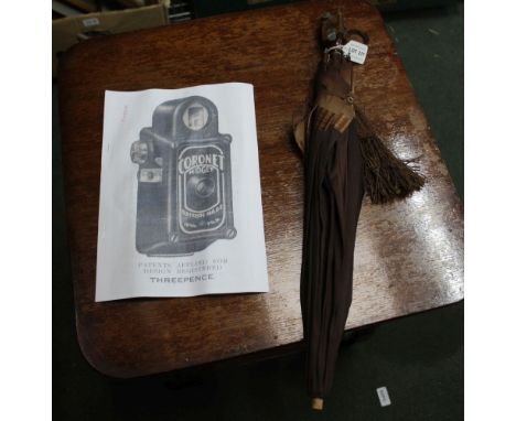 AN ORIGINAL VINTAGE LADY'S PARASOL, the handle formed as a coronet miniature camera, complete with facsimile of original adve