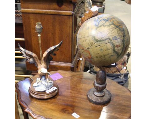 A REPRODUCTION TABLE GLOBE together with a table lamp, in the form of a spread eagle 