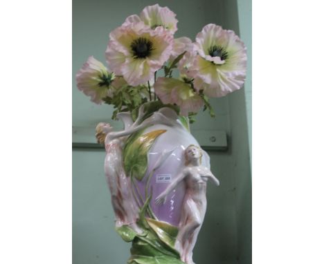 A LARGE DECORATIVE CERAMIC VASE containing everlasting oversized flowers 