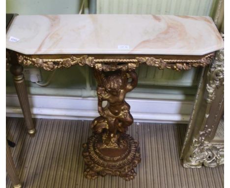 AN ONYX TOPPED MODERN CONSOLE TABLE having fancy pierced moulded gilded base, held aloft by a model putti, on four paw footed
