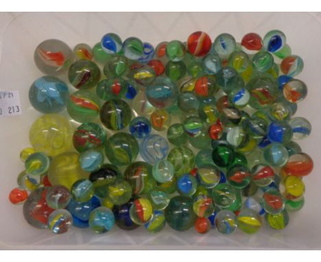 A plastic tub containing vintage marbles