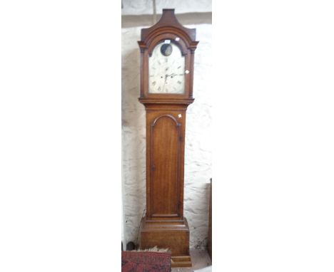 An early 19th Century oak longcase clock, the 29cm silvered arch dial with rocking galleon action, seconds dial and date aper