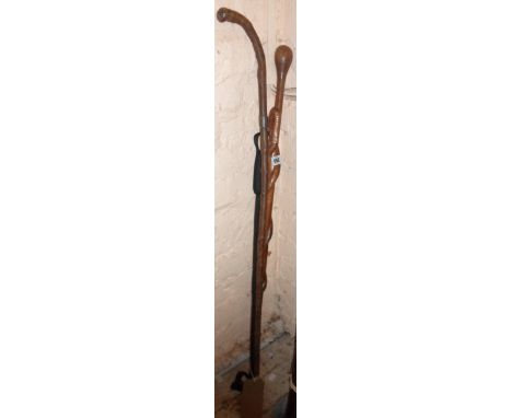 A walking stick carved with a serpent eating a lizard - sold with a silver collared stick and a riding crop