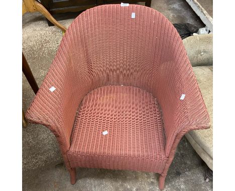 A vintage Lloyd Loom tub chair with original old rose sprayed finish and paper label