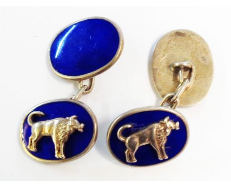 A pair of marked Silver and blue enamel oval panel cuff-links with applied bull motifs
