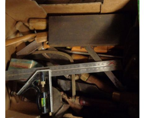 A box containing a quantity of tools including axe head, chisels, etc.