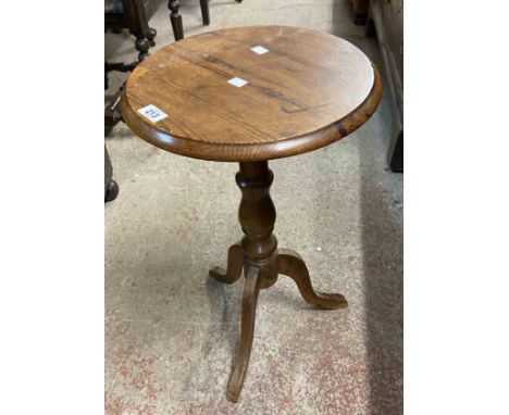 A modern polished pine pedestal wine table with tripod base