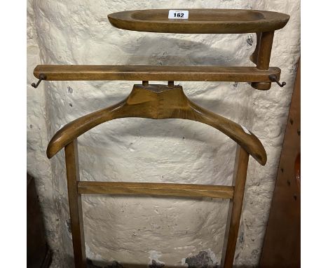 A vintage stained wood valet stand with cuff-links tray to top