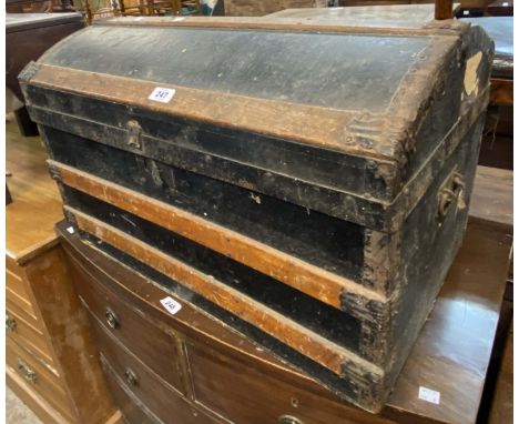 A small Victorian dome-top travelling trunk with weather coating and flanking iron drop handles - tray missing