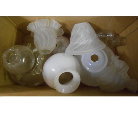 A box containing a quantity of oil lamp shades and chimneys