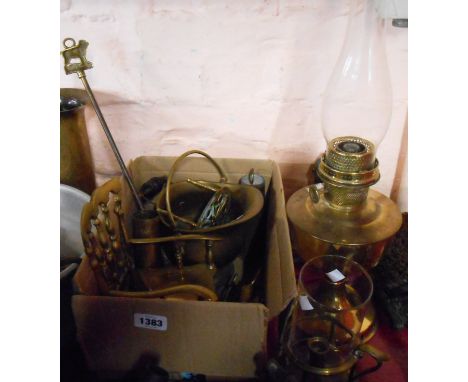 A box containing a selection of brassware including model rocking chair, WWII brass shell cases, etc. - sold with a brass oil