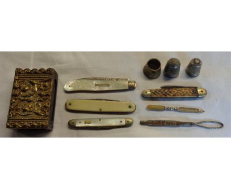 A silver and mother-of-pearl fruit knife, other small penknives, two thimbles and a matchbox sleeve, etc.