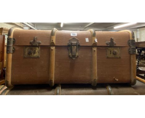 A vintage cane bound and weather coated travelling trunk - sold with another similar - old worm damage