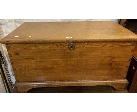 A 90cm Victorian waxed pine lift-top trunk with internal candle box, set on bracket feet - replacement hinges