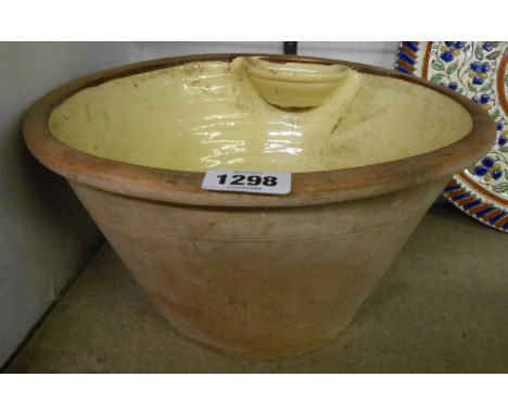 An antique slipware wash basin with applied soap holder - probably North Devon