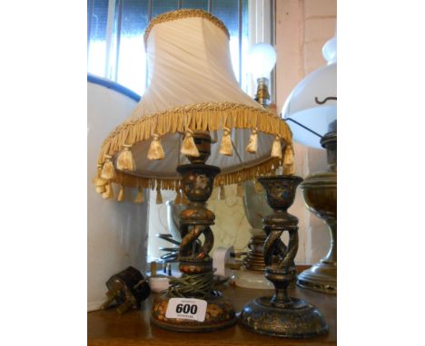 An Eastern wooden lacquered candlestick converted to a lamp - sold with another similar