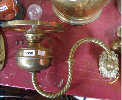 An old twin burner brass wall bracket form oil lamp with green glass shade - converted to electricity