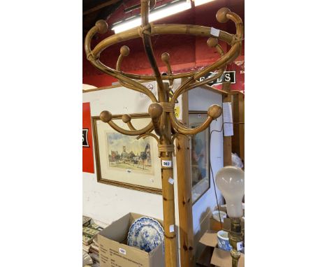 A vintage bamboo and cane freestanding hat and coat rack, set on tripod base