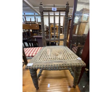 An antique bobbin turned framed child's chair with remains of rattan seat panel - sold with a simple rush seated similar - va