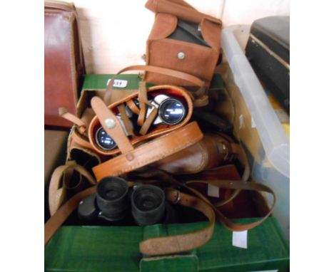 A box containing a quantity of vintage cameras including Kodak, Box Brownies, binoculars, etc.