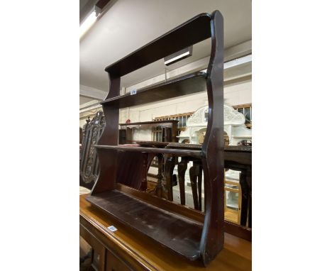 A 63cm antique stained wood wall mounted four shelf open bookcase with shaped sides