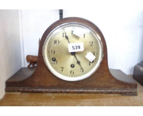 A vintage oak cased Napoleon hat mantle clock with eight day chiming movement