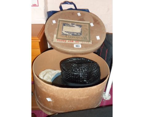 A vintage pressed card hatbox containing a small quantity of hats