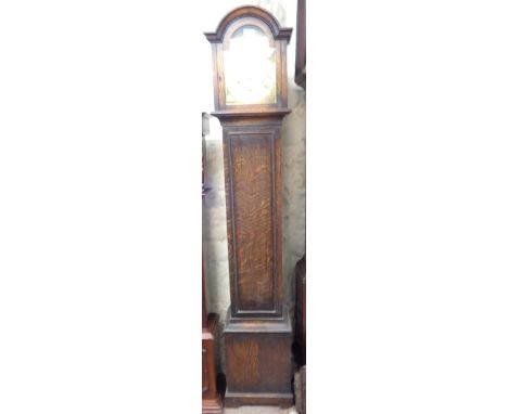 A vintage oak cased grandmother clock with silvered and brass arched dial, with spring driven eight day chiming movement