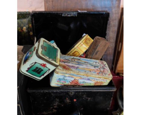 A small old japanned metal trunk containing a quantity of tins