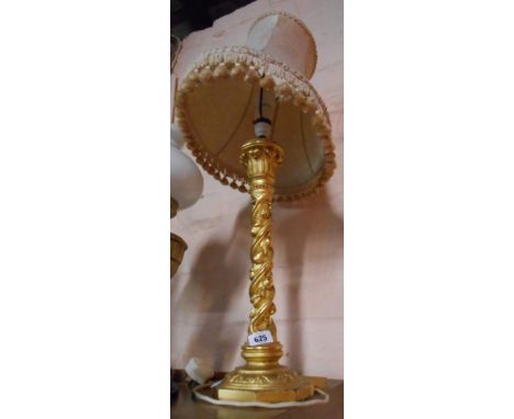 A carved giltwood table lamp of column form with fruiting spirals and acanthus terminal