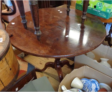 A 75cm antique mahogany tilt-top table, set on turned pillar and tripod base with pad feet - top split