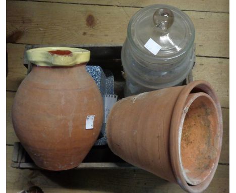 An old wooden storage box containing assorted items including vintage sweet jar, terracotta flower pots, jug, etc.