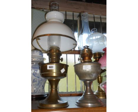 An old brass oil lamp with chimney and white opaque glass shade - sold with a similar plated example (no shade)