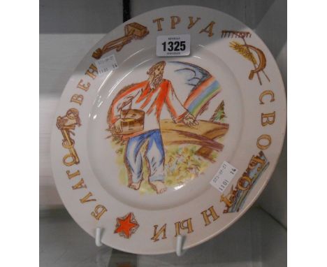 A vintage USSR propaganda plate depicting a peasant sowing with Soviet motifs to the border