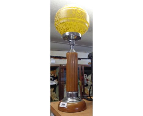 An Art Deco period phenolic and chrome table lamp with central amber coloured column, wooden base, chrome gallery and mottled