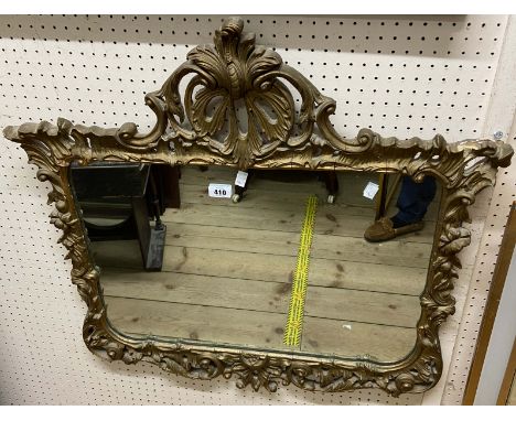 A vintage Rococo style gilt framed wall mirror with ornate pediment and shaped plate - minor loss