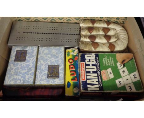 A box containing a quantity of playing cards, games, cribbage board, etc.
