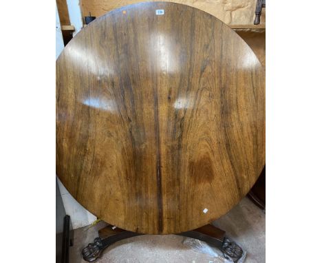 A 1.25m diameter 19th Century mahogany breakfast table, set on faceted tapered pillar and trefoil base with lion paw feet